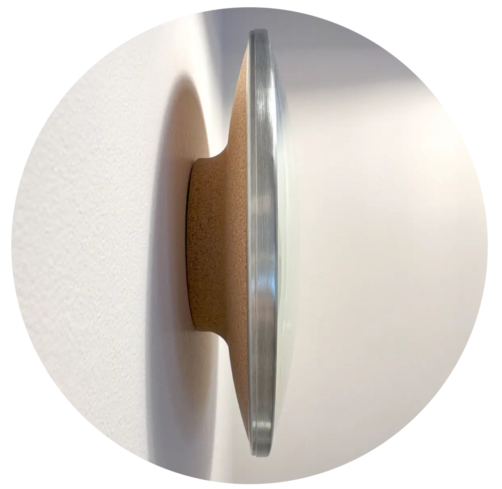 Close-up of The Present with a solid crock back and brushed stainless steel rings on a white background
