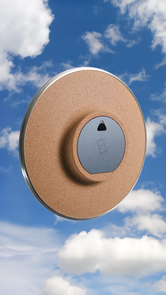 The back of The Present - Year (steel + glass) floating amongst the clouds in thin air.